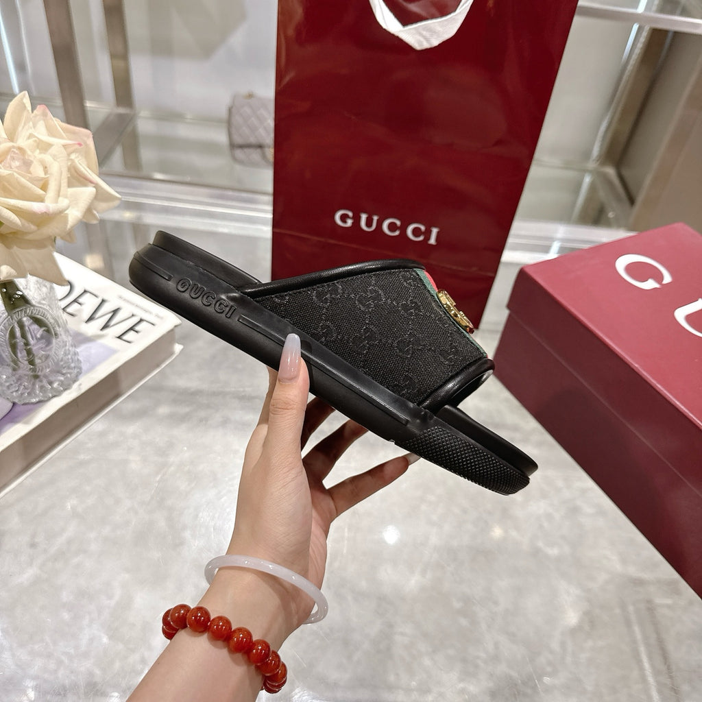 Black slide sandal sole side profile with green-red stripe strap and gold G buckle