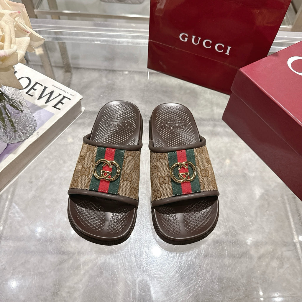 Gucci slide sandals with GG canvas strap, green/red web detail, gold-tone buckle, dark sole