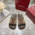 Gucci sandals with GG canvas strap, multicolor stripe, and gold double-G buckle detail