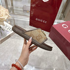 Gucci slide sandal sole and strap close-up with GG canvas and gold buckle