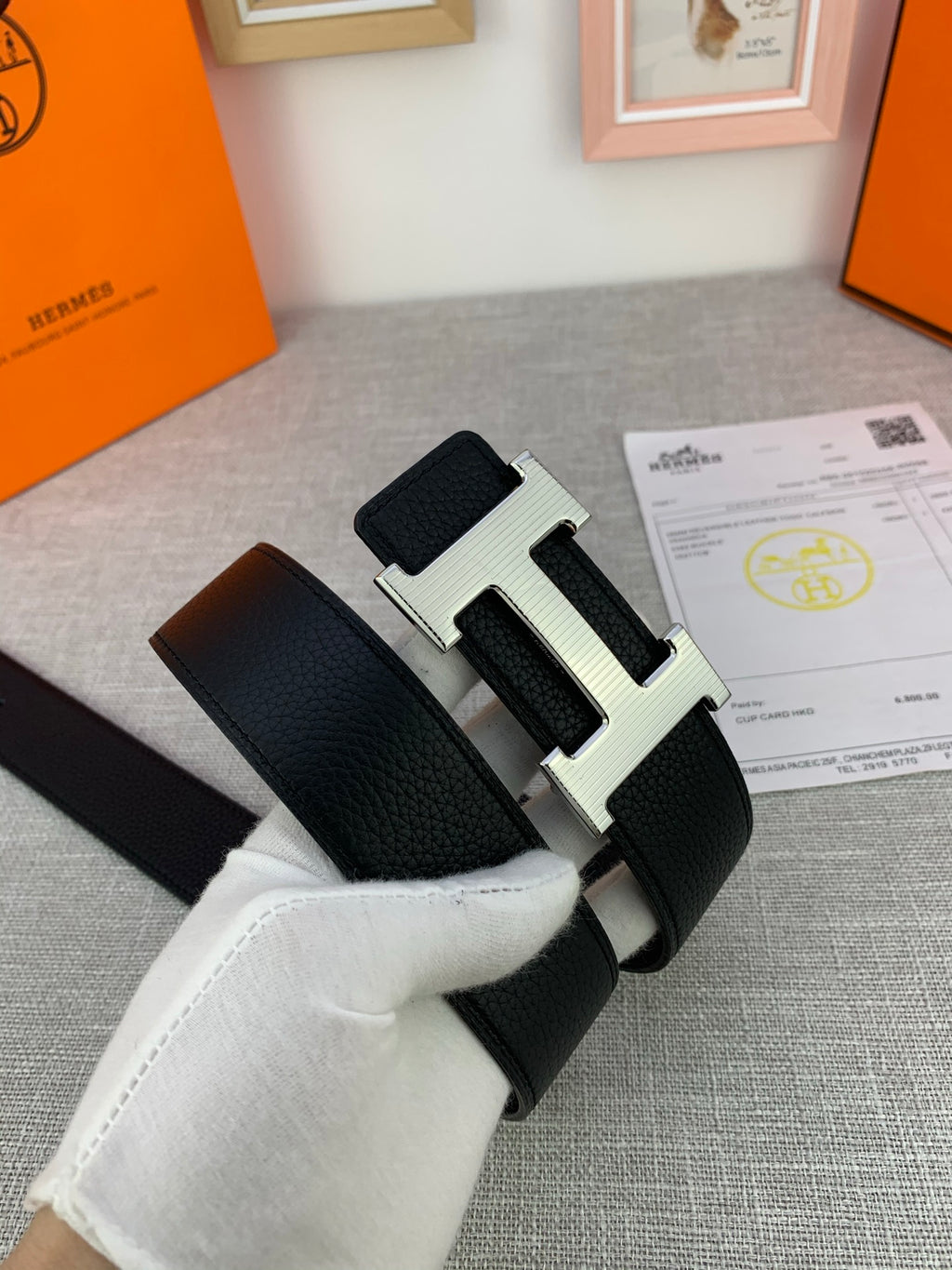 Black leather belt with silver-tone H buckle and textured strap