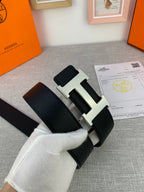 Black leather belt with silver-tone H buckle and textured strap