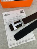Hermes belt close-up on receipt: dark leather strap and silver-toned H buckle