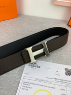 Hermes belt close-up: dark leather strap with silver-toned H buckle and keeper