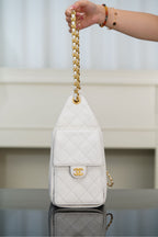 Chanel bag in white quilted leather with gold chain handle and CC logo on flap.