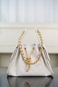 Chanel bag in white quilted leather with gold chain handles and CC clasp.