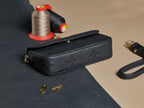 Louis Vuitton monogram top handle bag, black textured leather, gold hardware, chain strap
