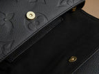 Louis Vuitton monogram leather bag with gold snap button and embossed texture
