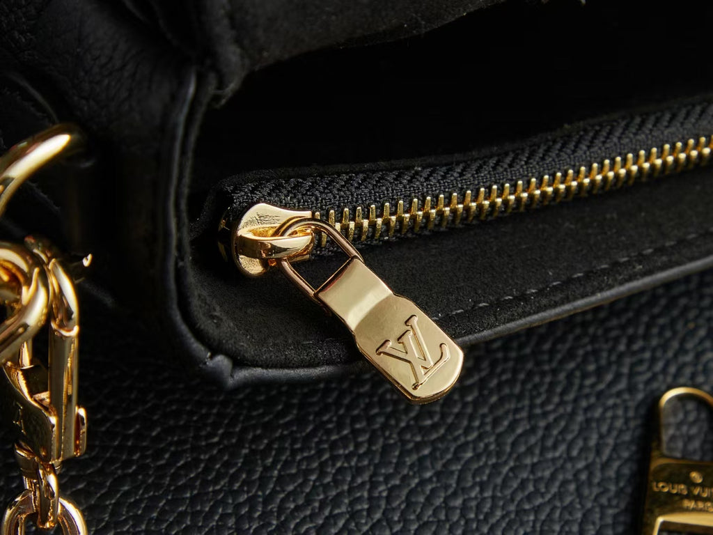 Louis Vuitton gold zipper pull on black textured leather with chain