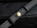 Louis Vuitton leather strap detail with gold logo buckle, black