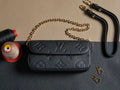Louis Vuitton monogram flap shoulder bag with gold chain strap, black textured leather