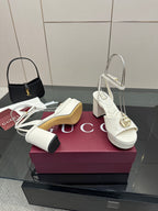 Gucci women's white heeled platform sandals with gold logo buckle and back ankle straps