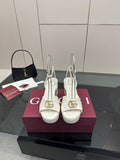Gucci women's white platform heeled sandals with gold logo buckle and ankle strap