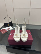 Gucci women's white platform heeled sandals with gold logo buckle and ankle strap