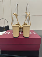 Women's cream sandals showing back straps and chunky block heels with gold-tone Gucci detail