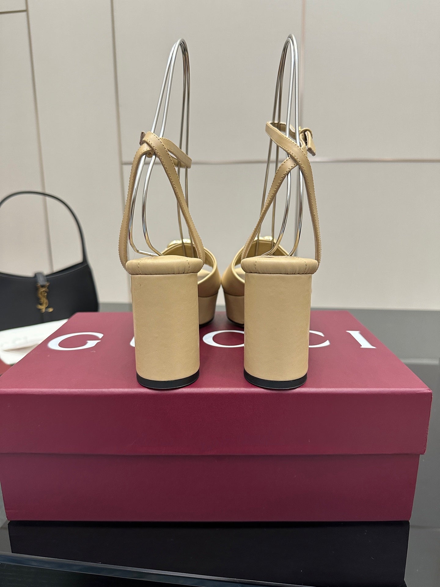 Women's cream sandals showing back straps and chunky block heels with gold-tone Gucci detail