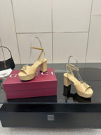Women's cream slingback sandals with gold-tone Gucci emblem buckle and block heel