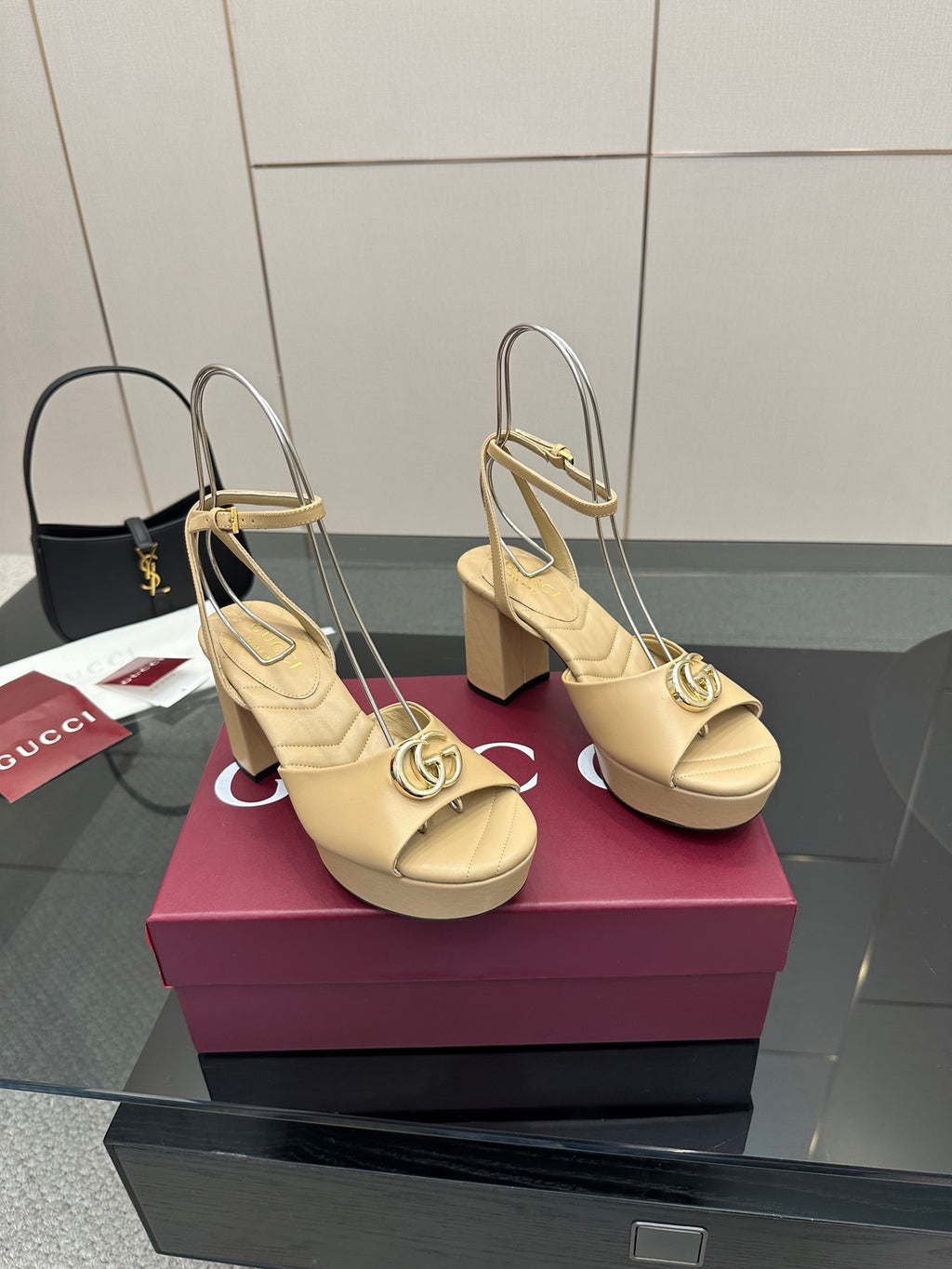 Women's cream platform heeled sandals with gold-tone Gucci medallion buckles