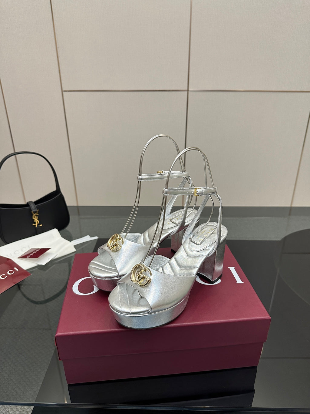 Silver metallic heeled sandals with gold logo detail, open toe and thin ankle strap