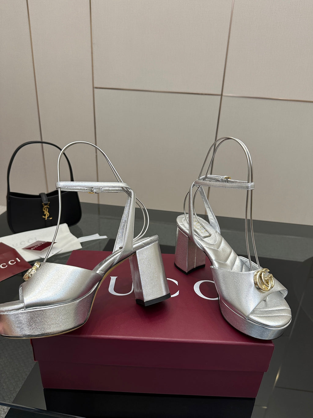Silver metallic heeled sandals with gold logo emblem, open toe and thick heel platform
