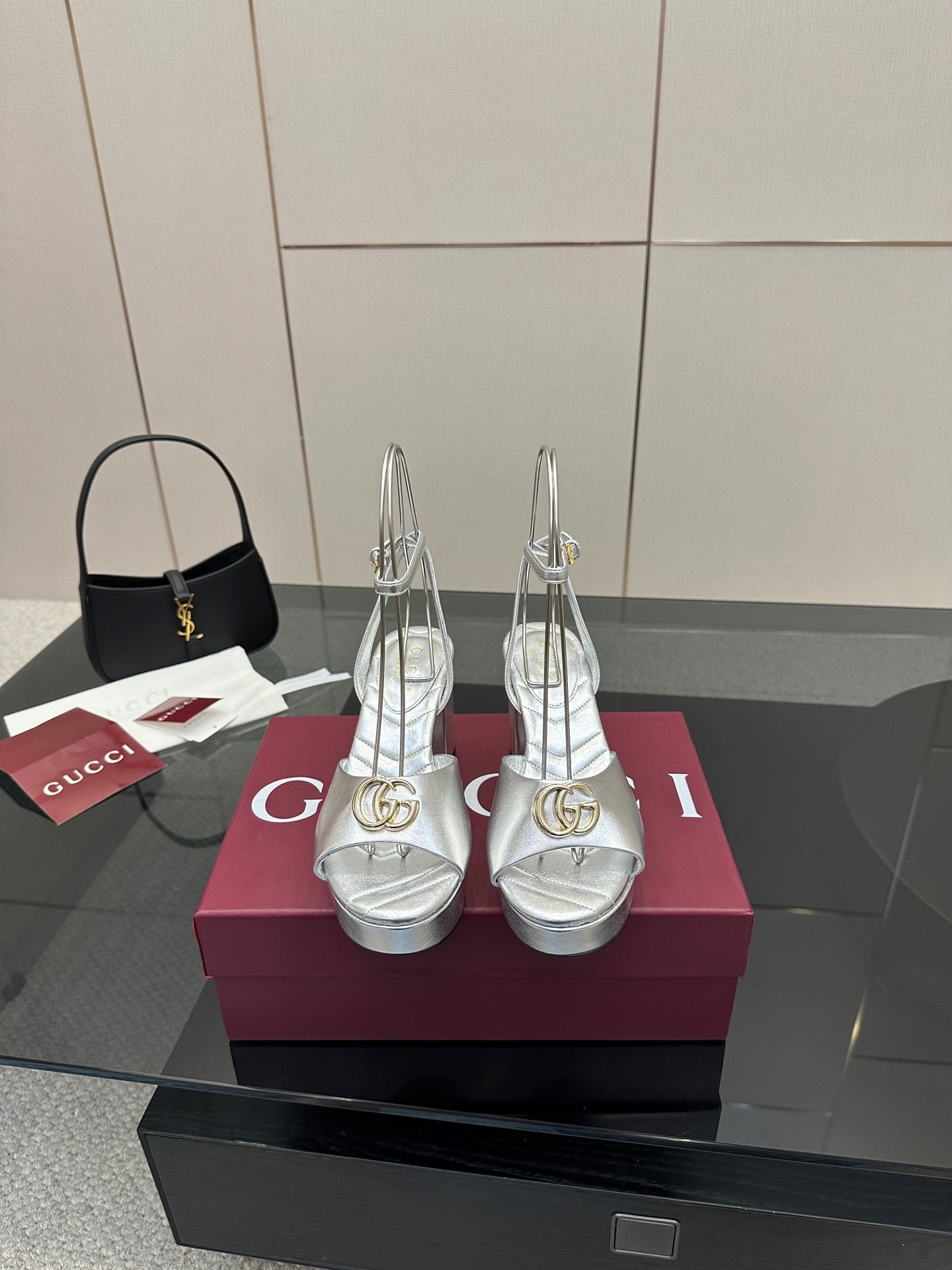 Silver platform heeled sandals with gold logo hardware, open toe, slim ankle strap