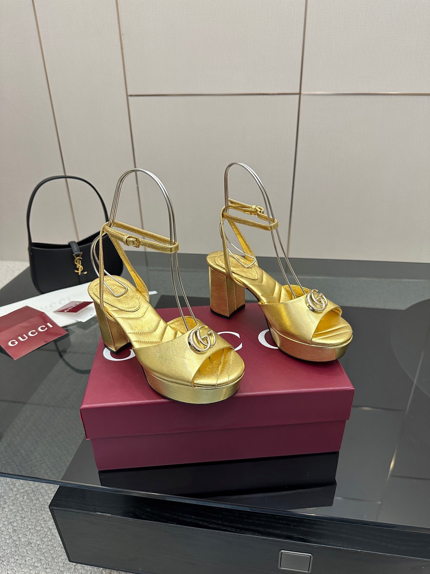 Gucci metallic gold heeled sandals with peep toe, logo detail, and chunky heel
