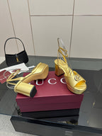 Gucci metallic gold heeled sandals with logo detail, peep toe, and block heel