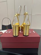 Gucci metallic gold heeled sandals viewed from the back, with ankle straps