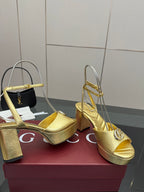 Gucci metallic gold heeled sandals with logo strap, peep toe, and platform sole