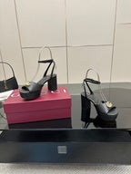 Gucci black platform heeled sandals with gold logo buckle and open toe slingback