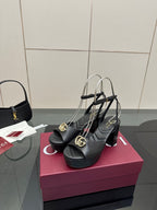 Gucci black platform heeled sandals with gold logo buckle and thin ankle straps
