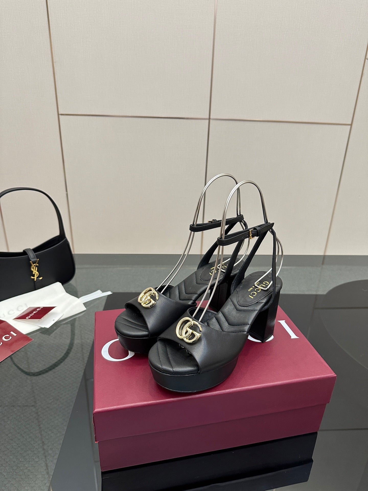 Gucci black platform heeled sandals with gold logo buckle and thin ankle straps