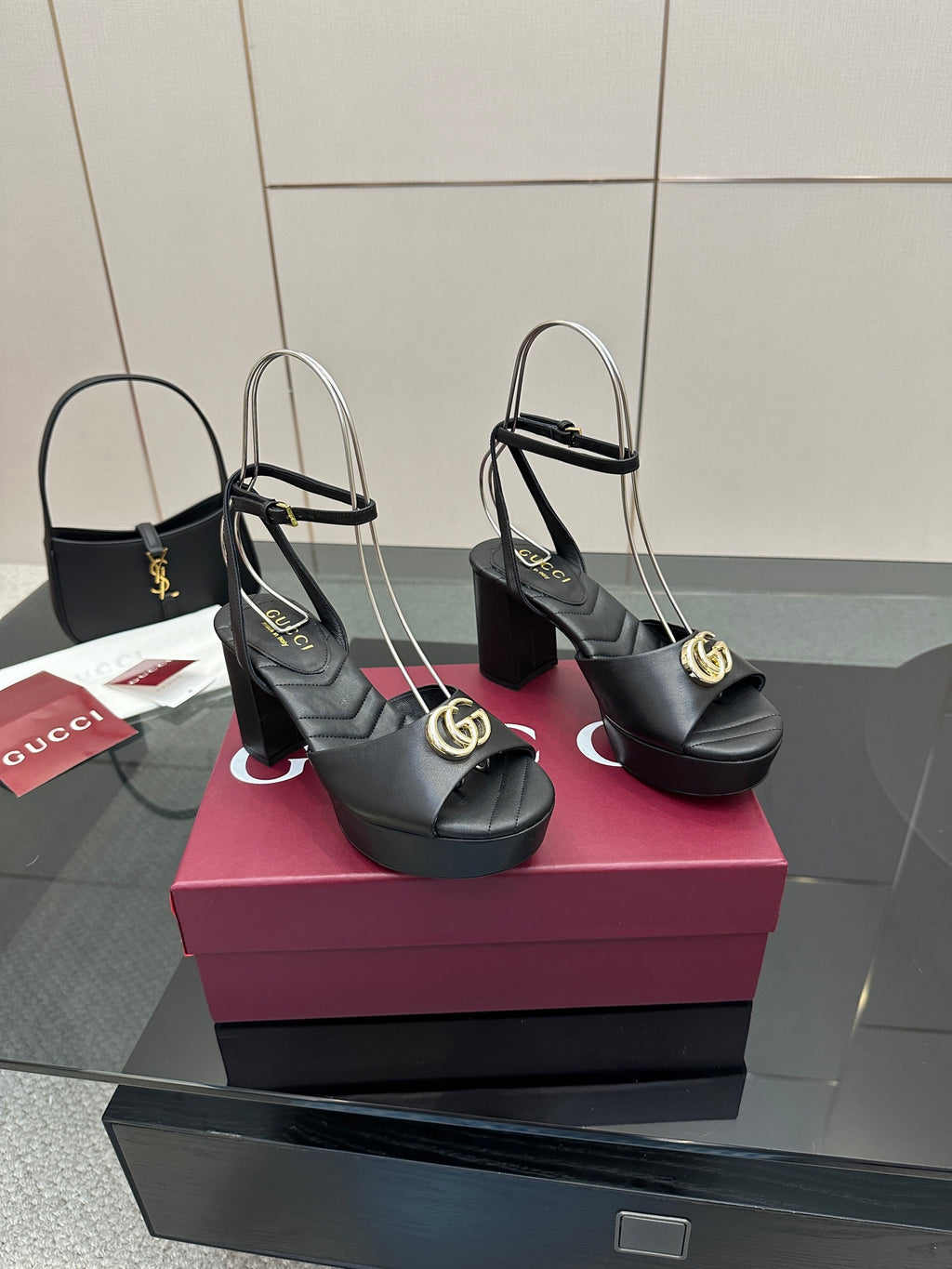 Gucci black platform heeled sandals with gold logo buckle and open toe slingback