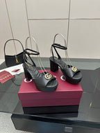 Gucci black platform heeled sandals with gold logo buckle and open toe slingback