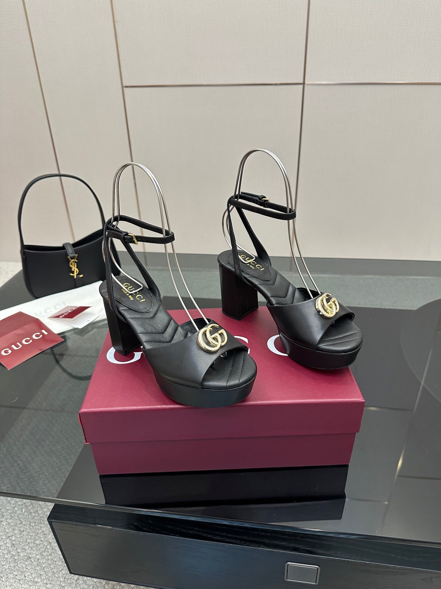 Gucci black platform heeled sandals with gold logo buckle and open toe slingback