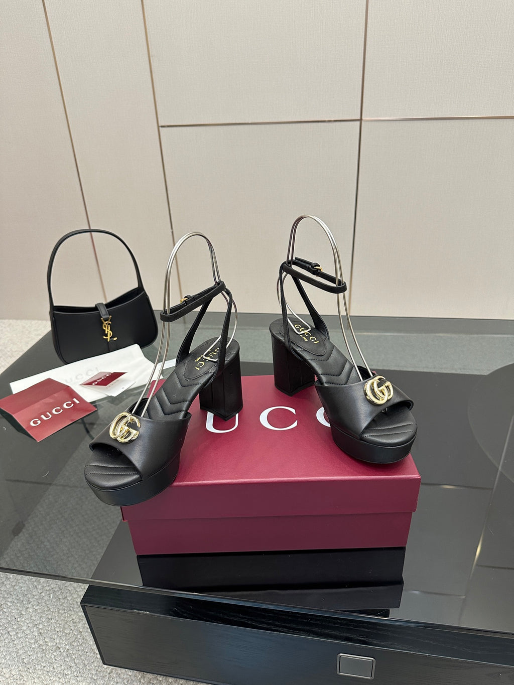 Gucci black platform heeled sandals with gold logo buckle and adjustable ankle strap