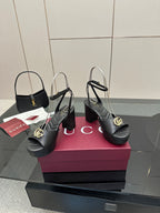 Gucci black platform heeled sandals with gold logo buckle and adjustable ankle strap