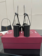 Gucci black platform heeled sandals with gold logo buckle and tall stiletto-like heel