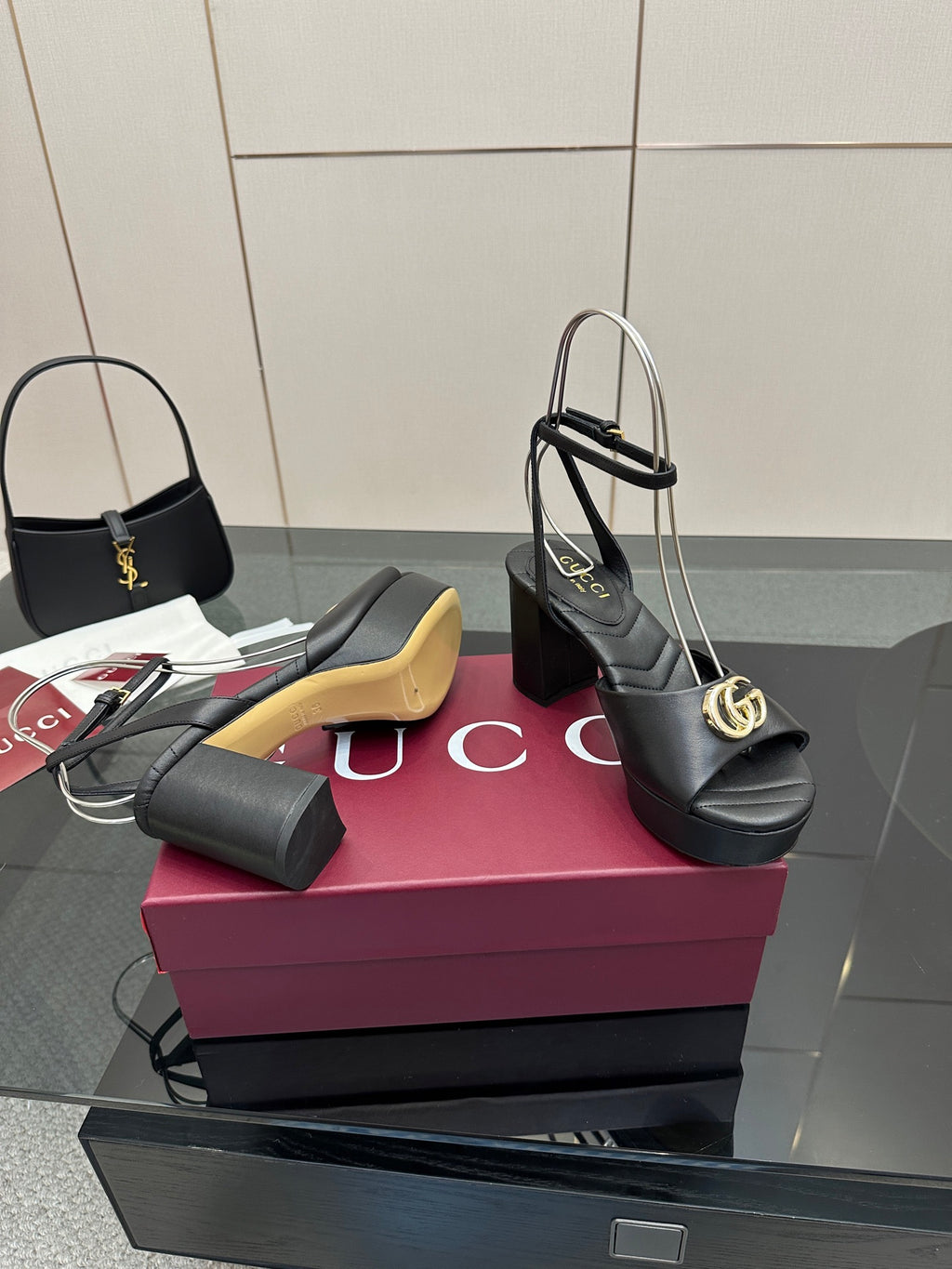 Gucci black platform heeled sandals with gold logo buckle and thin ankle straps