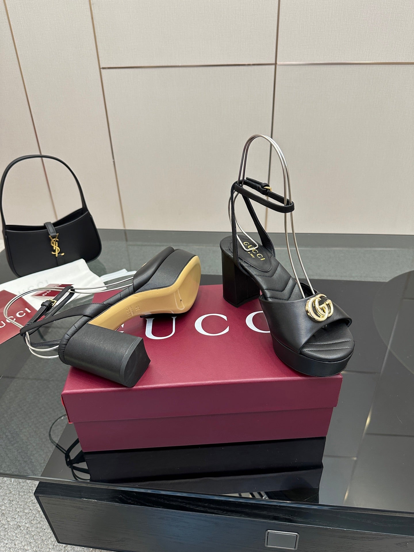 Gucci black platform heeled sandals with gold logo buckle and thin ankle straps