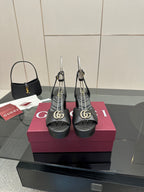 Gucci platform heeled sandals in black with gold logo buckle and sling straps