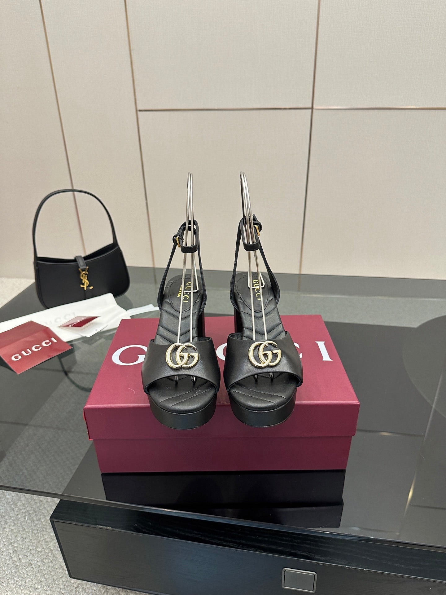 Gucci platform heeled sandals in black with gold logo buckle and sling straps