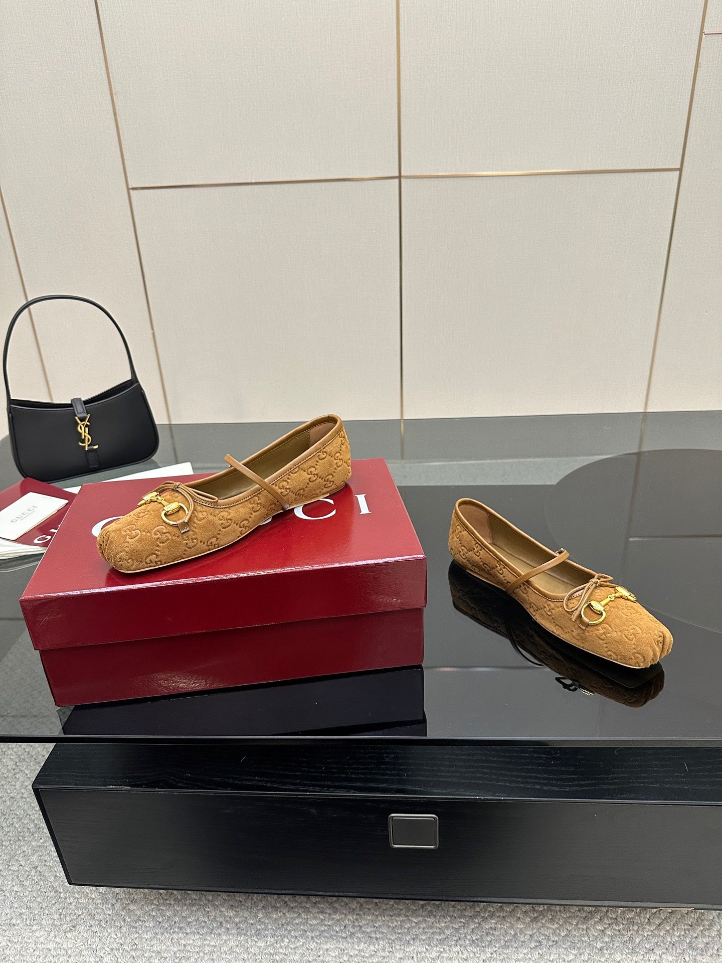 Gucci ladies loafers in tan patterned fabric with gold-tone horsebit hardware, angled view