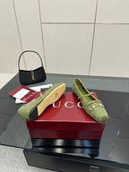 Green patterned Gucci loafers, side-by-side view with gold horsebit and slip-on silhouette