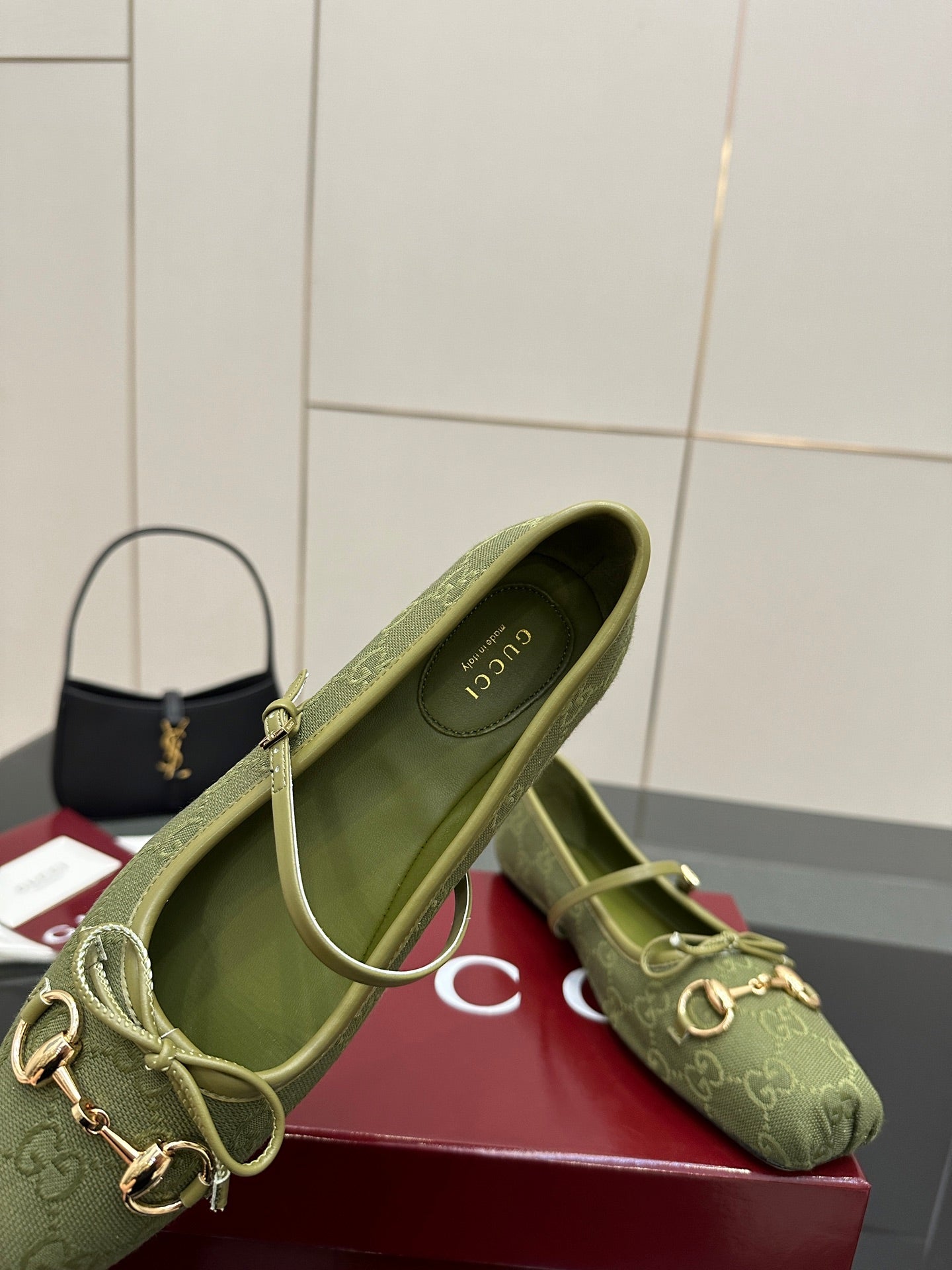 Green patterned Gucci loafer, close-up side view with gold horsebit and interior lining