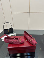 Gucci ladies pink textured flats with gold-tone hardware, side view on display box.