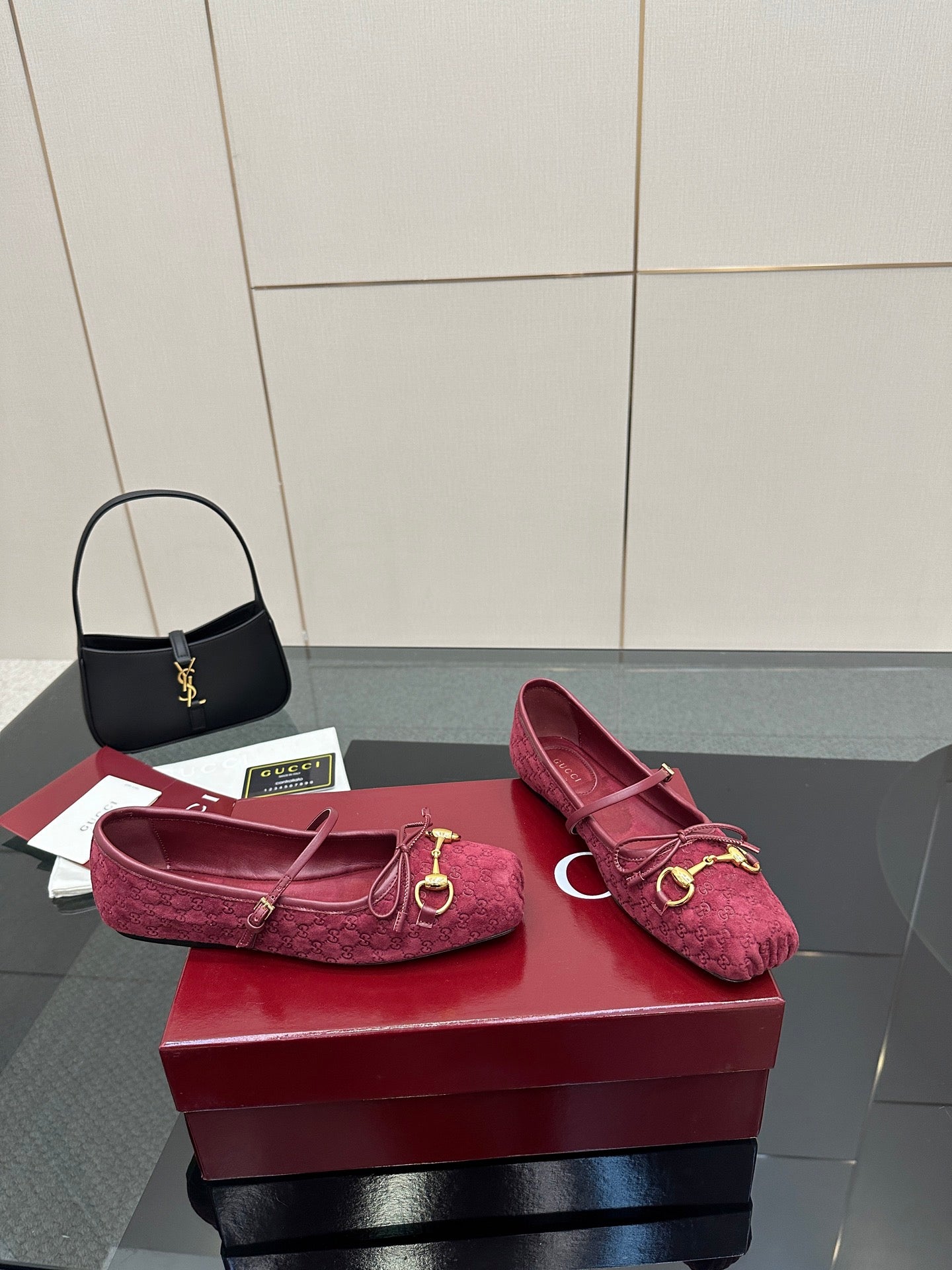 Gucci ladies pink textured flats with gold-tone hardware, side view on display box.