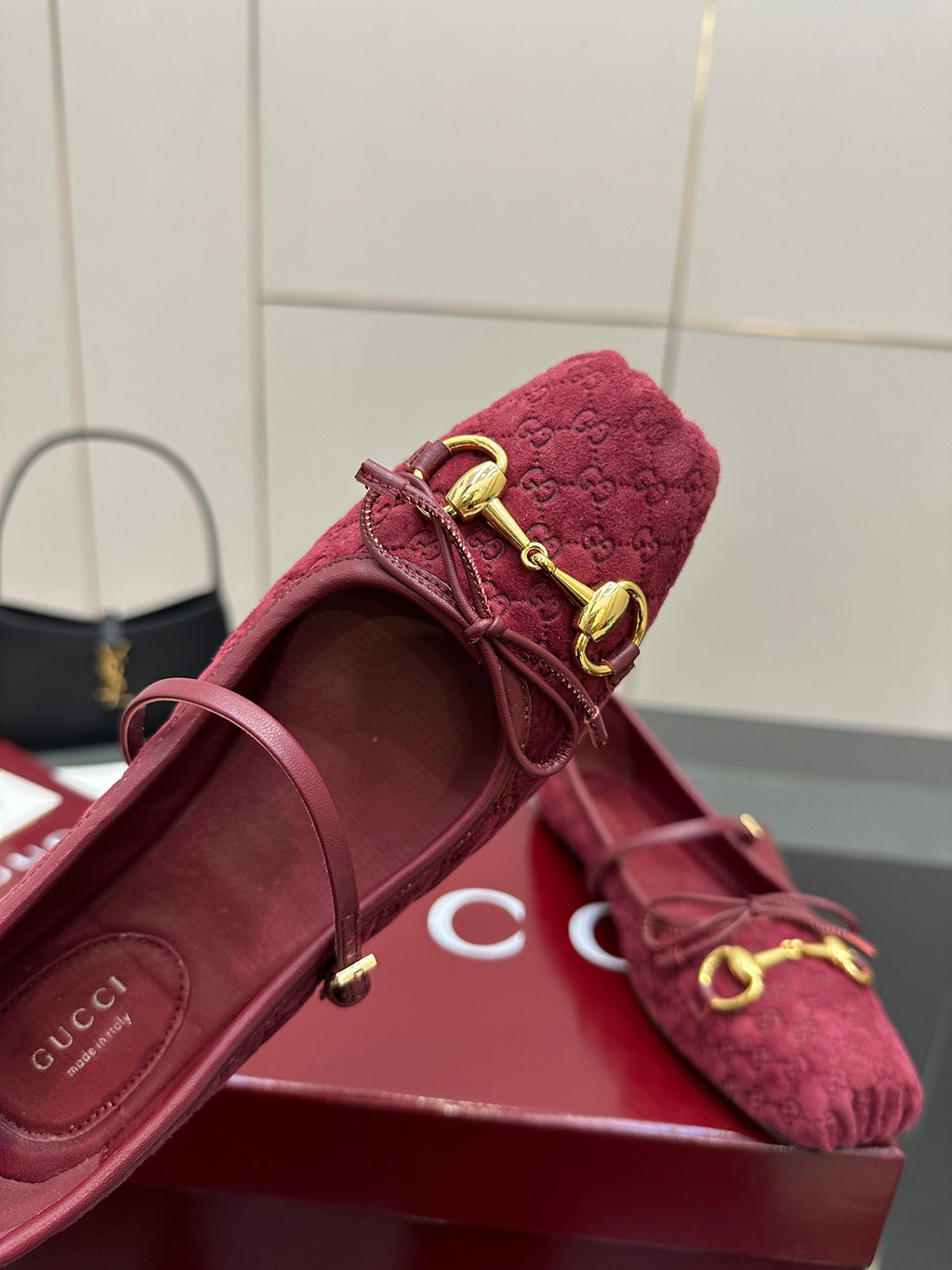 Gucci ladies pink textured loafer close-up with gold-tone laces and bit hardware.