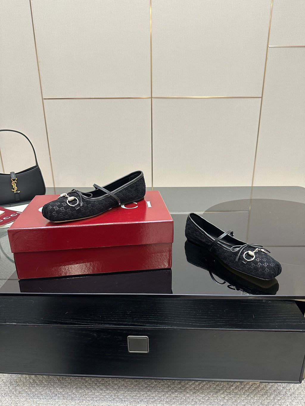 Gucci black loafers with metal bit hardware on patterned upper, side angle view