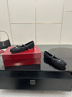 Gucci black loafers with metal bit hardware on patterned upper, side angle view